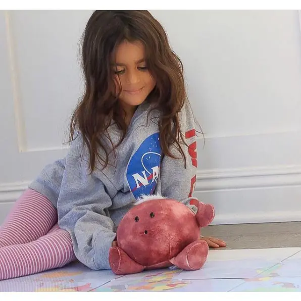 Girl playing with Celestial Buddies Mars Buddy