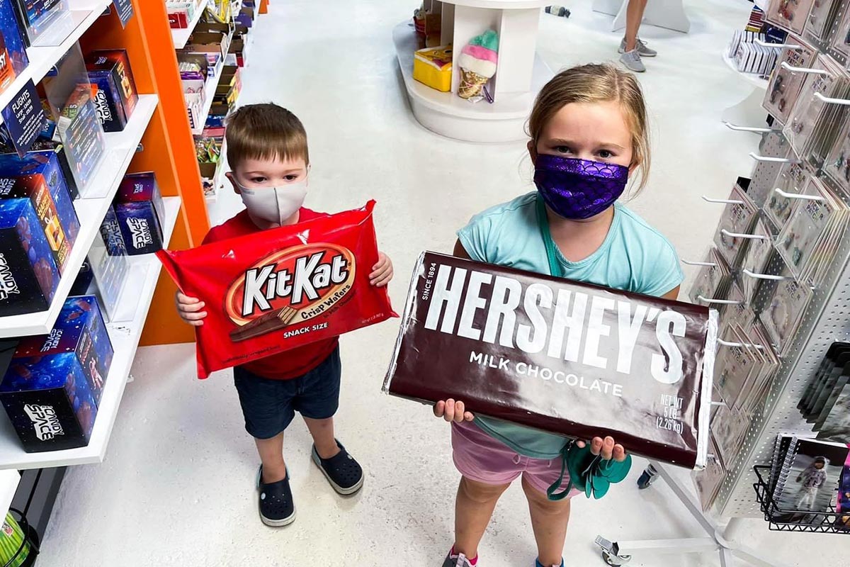 Kids posing with giant candy bars