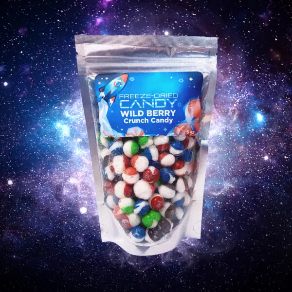 freeze dried wild berry crunch candy packet with space themed background to demonstrate product and theme